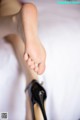 A close up of a woman's feet in high heels.