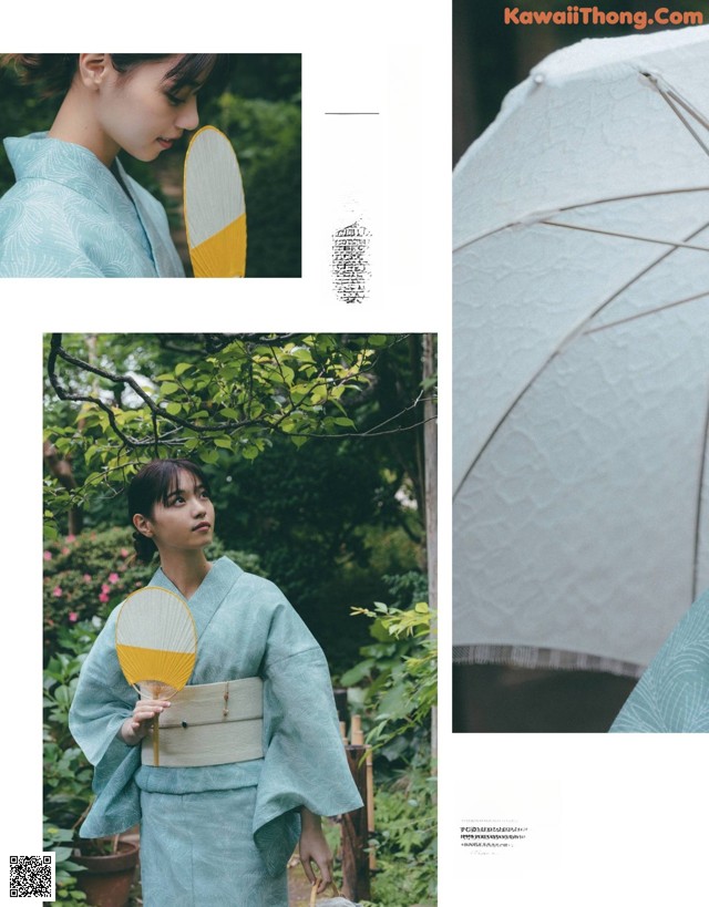 A woman in a blue kimono holding an umbrella.