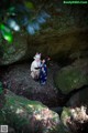 A couple of people standing next to each other in a cave.